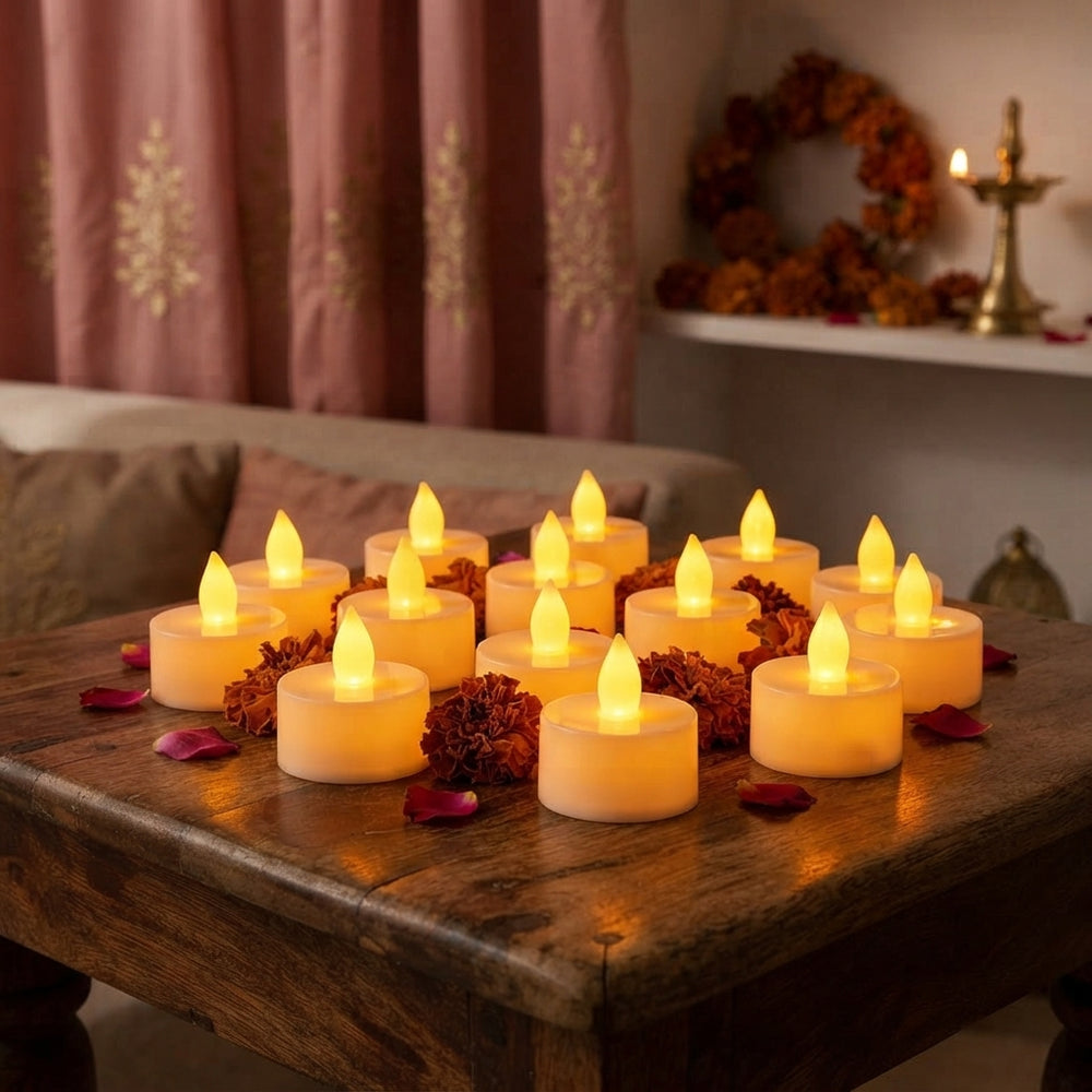 A close-up of several glowing LED diya candles arranged on a wooden table, creating a warm and festive atmosphere in a home.